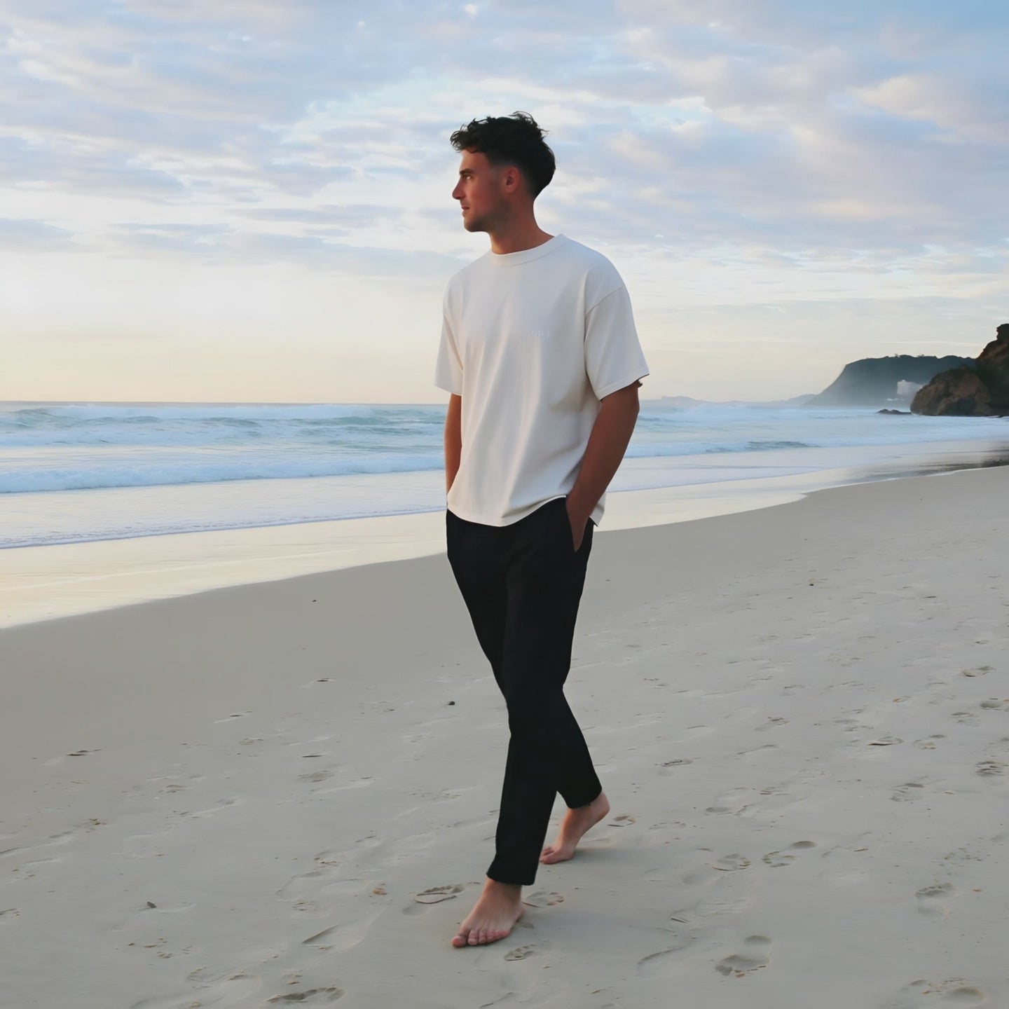 Model walking on the beach at sunrise